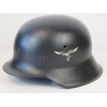 A reproduction WWII Luftwaffe helmet having single decal with liner and chin strap.