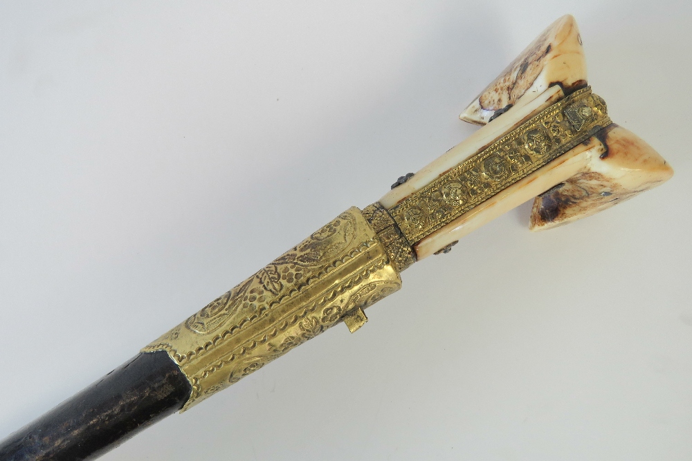 A mid 19thC Turkish Yataghan sword with silver damascened inscribed blade,