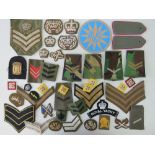 A large quantity of cloth military badges including ACF, AVG, shoulder boards, Royal Yacht, etc.