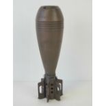 An inert WWII US 81mm mortar round with fins and flaming bomb stamp, dated 1944.