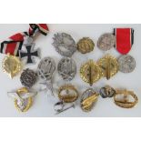 A collection of German reproduction badges and medals.