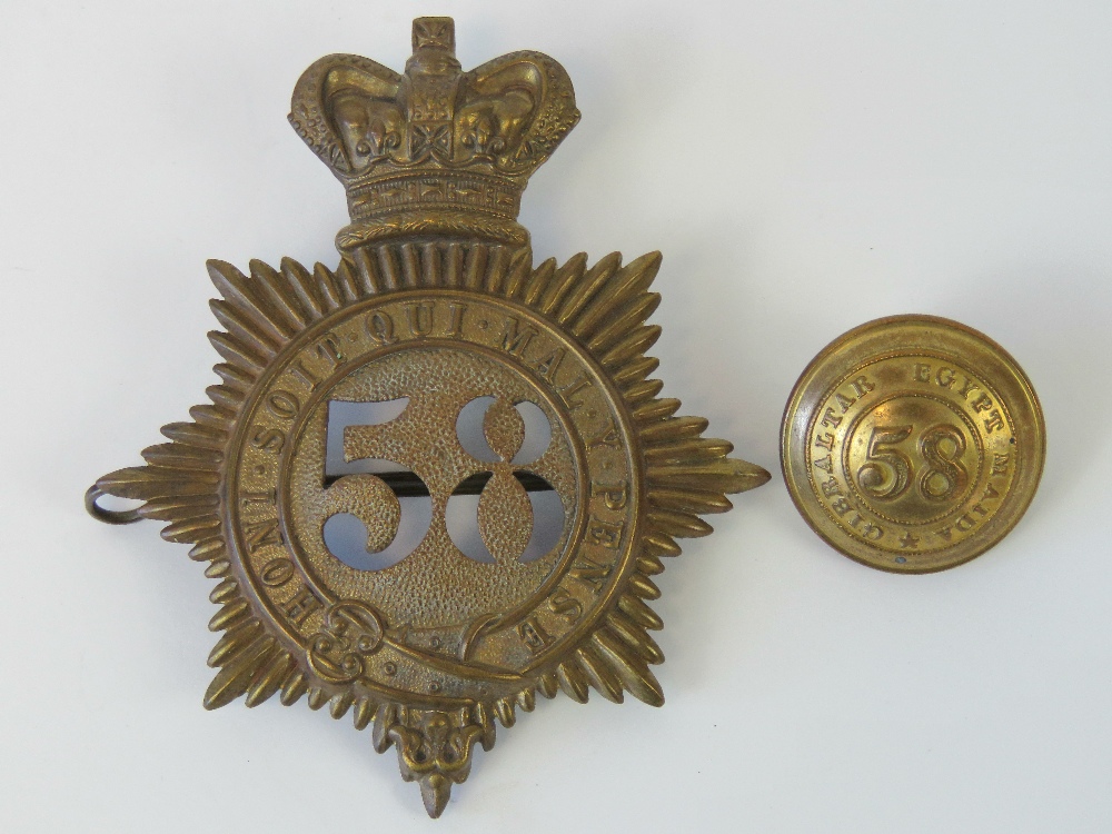 A Victorian shako plate helmet badge and matching tunic button for the 58th Regiment (Rutland).