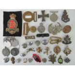 A quantity of military badges, buckles,