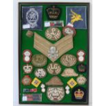 A framed board of assorted WWII and post