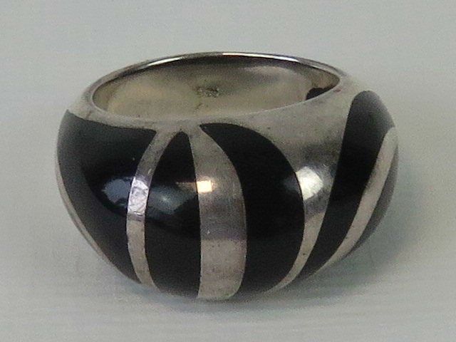 A silver ring with unusual black enamel striped design, stamped 925, size M-N.