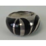 A silver ring with unusual black enamel striped design, stamped 925, size M-N.