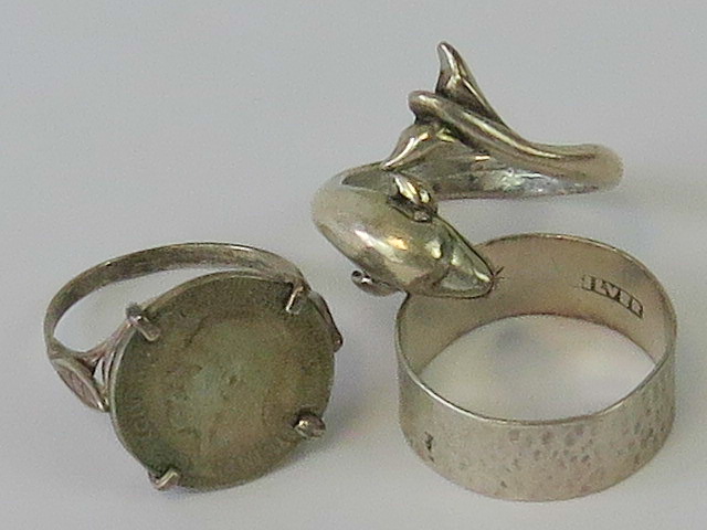 Three silver rings; one in the form of a