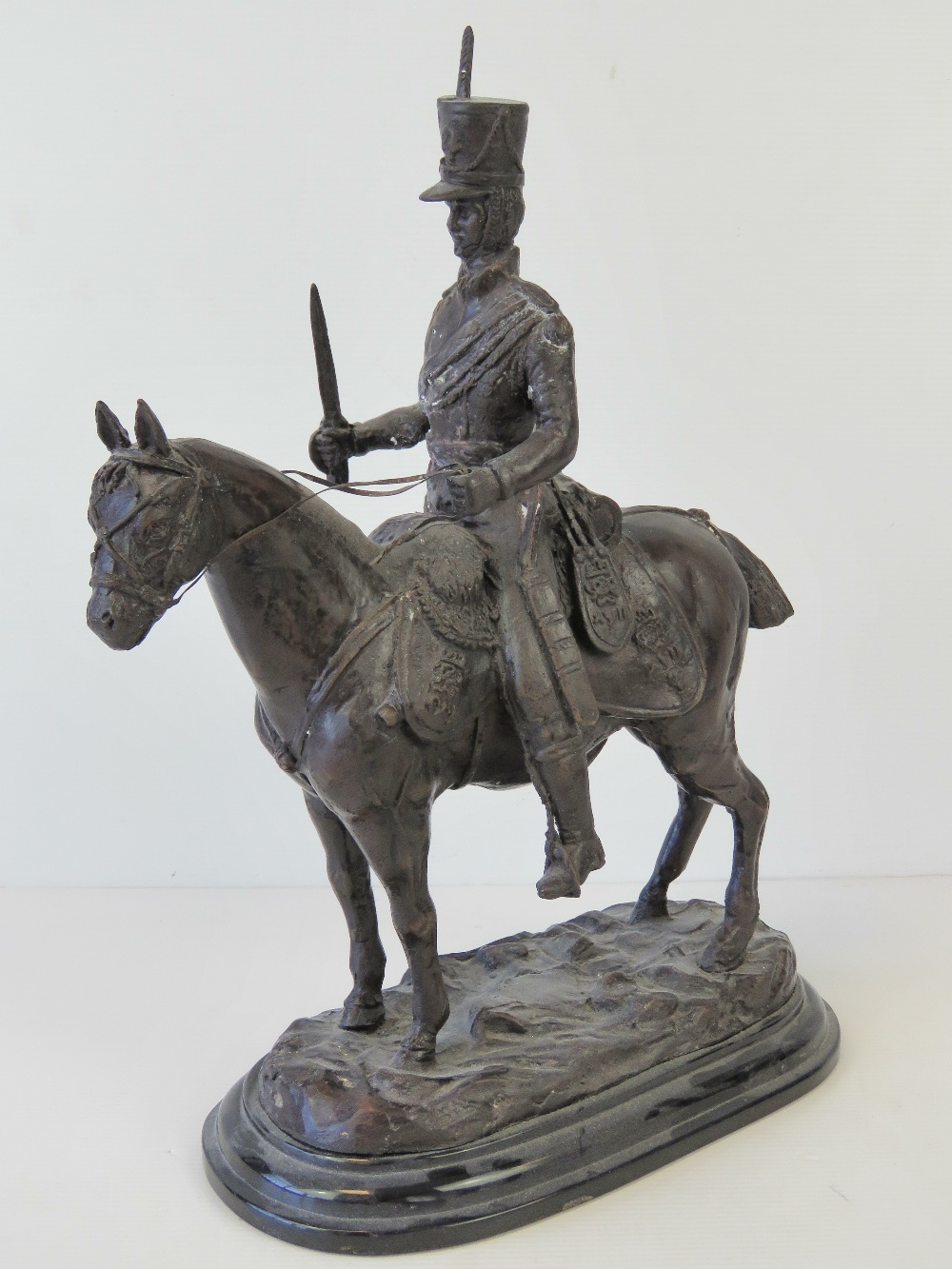 A bronzed patinated figure of a mounted