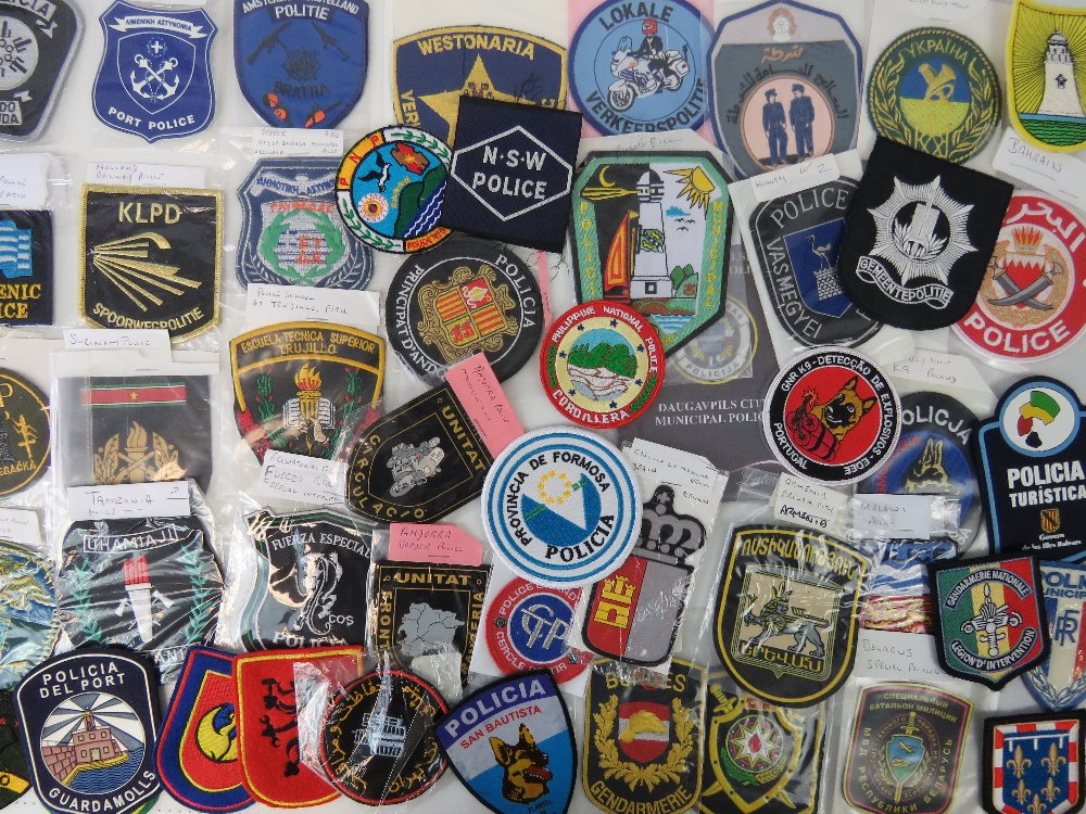 Fifty assorted cloth police badges.