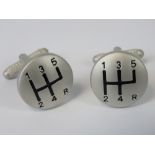 A pair of cufflinks in the form of manual gear shifts.