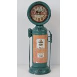 A contemporary clock in the form of a vintage petrol pump, standing 35.5cm high.