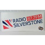 A contemporary Radio Silverstone 87.7FM fibre board sign, 45 x 100cm.