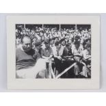A monochrome print of 1955 British Grand Prix at Aintree featuring Fangio in the crowd, 29cm x 39cm,