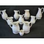 A quantity 19th century white ground stoneware jugs having relief moulded Classical, hunting,