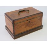 A 19th century lidded tea caddy having inlaid floral decoration in mahogany cross banded with