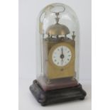 A delightful brass cased striking overmantle alarm clock having enamelled dial with Roman numerals,