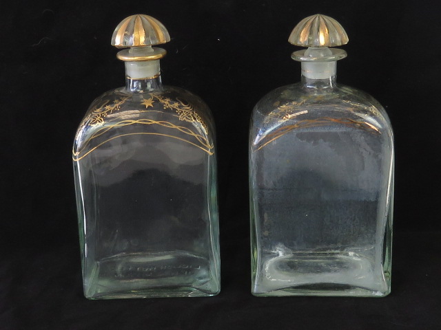 A pair of Georgian style gilded liquor bottles marked for Jerez Spain. each standing 21cm high.
