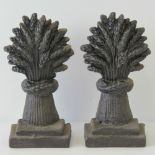 A pair of cast iron door stops each in the form of a wheatsheaf and standing 19cm high.