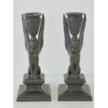 A pair of late Victorian Egyptian revival candlesticks,