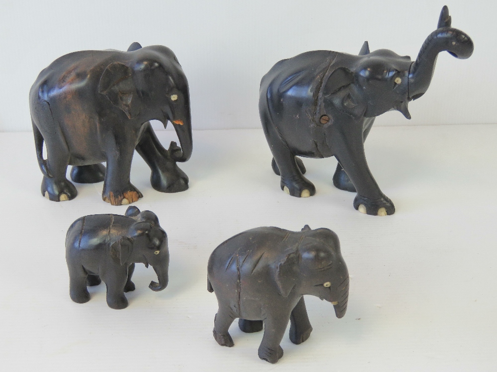 A set of four graduated ebony elephants, a/f.