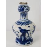 An 18thC Delftware bottle vase painted in blue with Chinese transitional style decoration of a bird,
