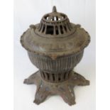 A vintage patented Omega heavy cast iron room heater of pierced circular form, standing 40cm high,