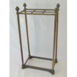 A brass Victorian umbrella stand with cast iron base, drip tray deficient, standing 61cm high.