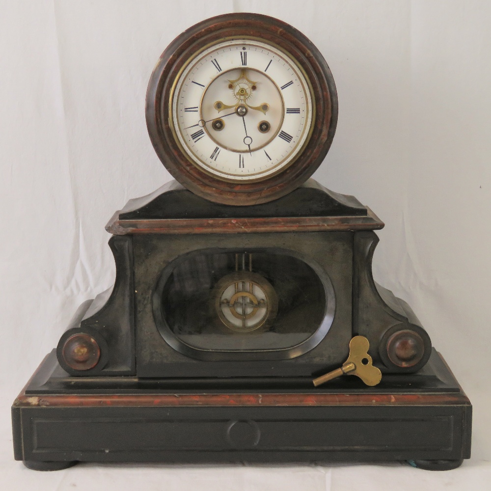 A substantial Victorian slate and marble over mantle clock having and eight day striking movement,