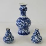 A Delftware bottle vase painted in blue in the Chinese manner with sprays of flowers,