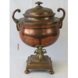 An impressive 19th century copper samovar raised over square shaped base stood on four ball feet,