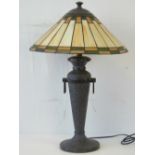 A modern Tiffany style table lamp with conical leaded light glass shade and slender beaten bronze