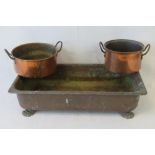 A large rectangular copper basin raised over four lions paw feet, 57 x 29cm.