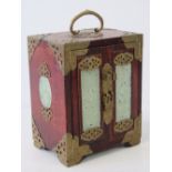 An early 20th century Oriental tea chest decorated with pierced brass corner bracing and jade