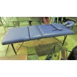 A purple leatherette massage table.