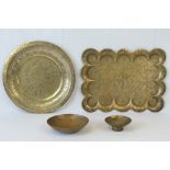 An Indian brass rectangular tray with lobed border, engraved with dancers amid foliate scrolls,