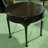 A mahogany demi-lune fold over tea table raised over plain tapering legs terminating in pad type