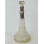 A delightful HM silver collared cut glass rum decanter complete with silver plated and mother of