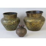 Two Indian embossed brass jardiniere together with a similar smaller copper jardiniere. Three items.