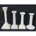 Four white pottery candlesticks, including one for the Oriental Ivory Pottery,