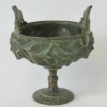 An ornate Oriental bronzed brass vessel raised over turned stem, 13cm high, 10cm dia, 614g.