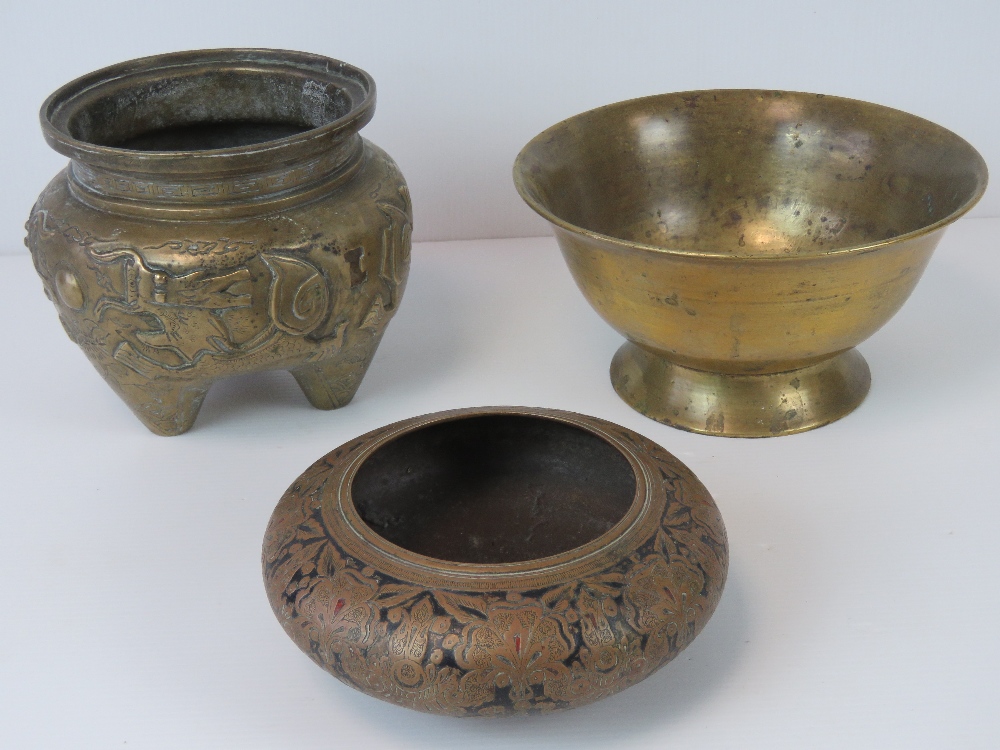 A Chinese brass censor of swollen tapered design incorporating three feet,