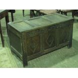 An early 18th century three panel coffer having later carving to fore panels,