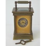 A brass cased French made carriage clock with silvered chapter ring, Arabic numerals,