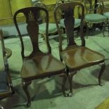 A good pair of 20th century mahogany solid seat hall chairs, solid splats, raised over shaped legs.