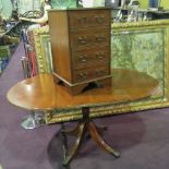 A reproduction Georgian style yew veneered oval drop leaf dining table on pedestal base and a