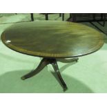 A reproduction mahogany oval low centre table raised over quatreform base, 122cm in length.