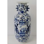 A 19thC Chinese blue and white vase hand painted with figures holding a large vase and prunus