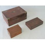 A Victorian walnut writing slope with inset brass shield and corner bracing,