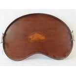 An Edwardian kidney shaped mahogany serving tray having inlaid conch shell pattern to centre,