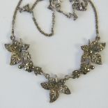 A vintage silver and marcasite necklace in the form of three leaves,